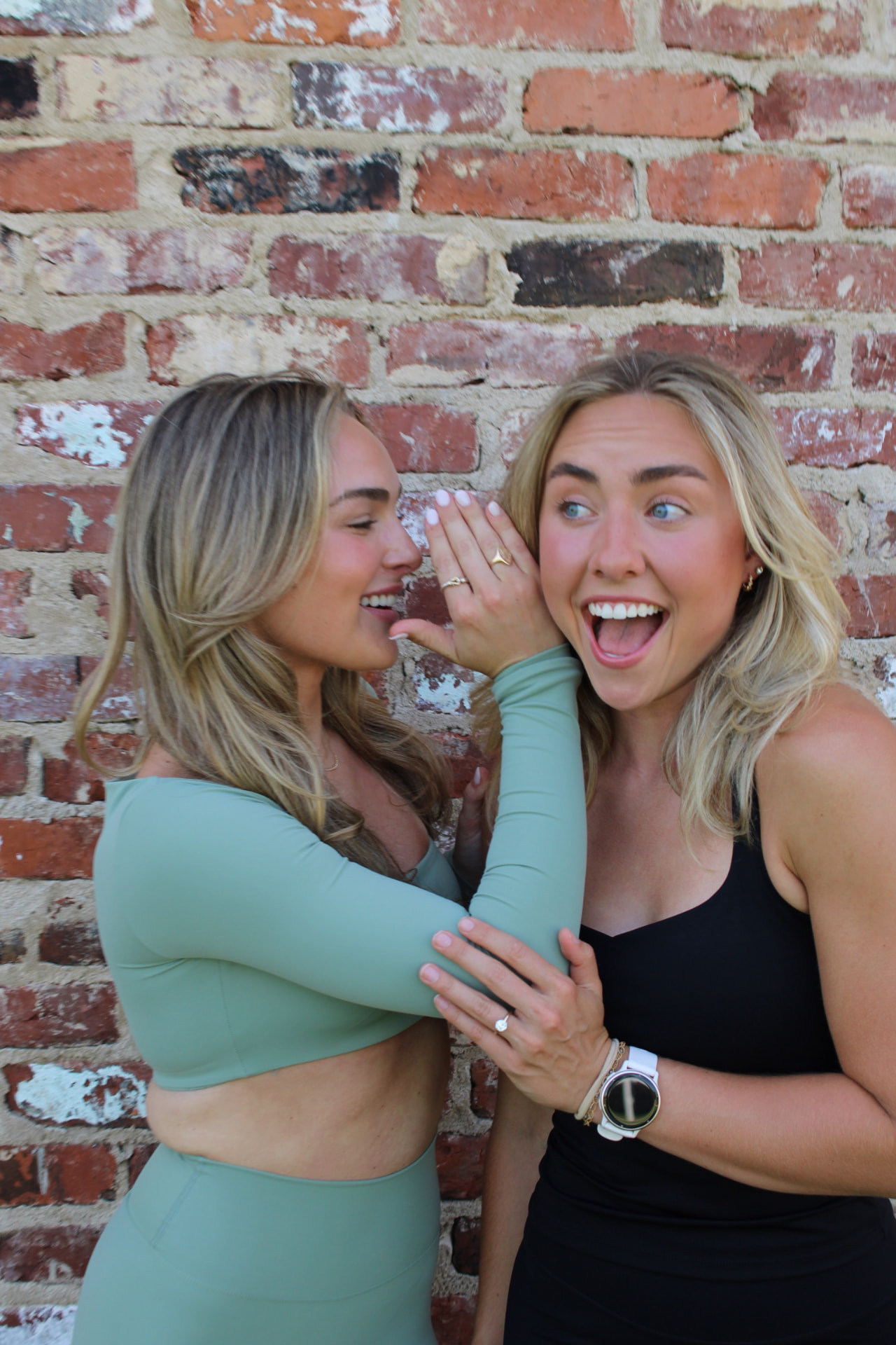 Two instructors laughing together in sage studio sets